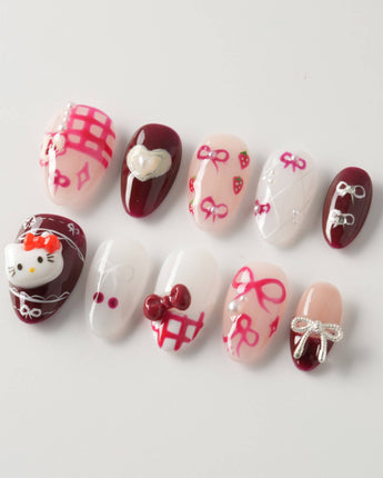 KT Cake press-on nails in extra short almond with cute cake accents and gel finish