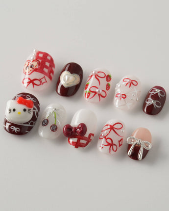 KT Cake press-on nails in extra short oval with cute dessert details and glossy finish
