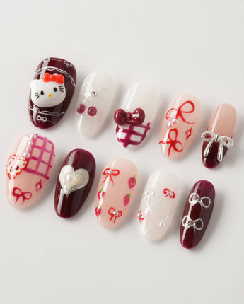 KT Cake press-on nails in medium oval with sweet dessert details and glossy polish