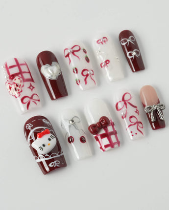 KT Cake press-on nails in medium square with sweet cake details and polished finish
