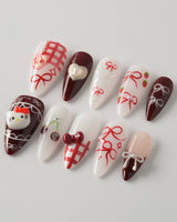KT Cake press-on nails in medium stiletto with cake-inspired accents and polished gel shine