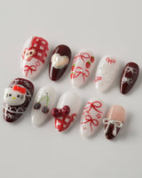 KT Cake press-on nails in short almond with sweet 3D details and cake-inspired styling
