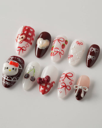KT Cake press-on nails in short almond with sweet 3D details and cake-inspired styling