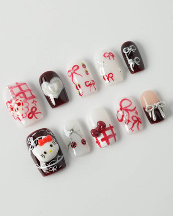 KT Cake press-on nails in short square with playful dessert accents and glossy gel