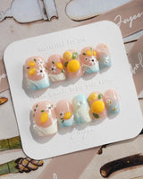 Lemon Shore close-up of hand-sculpted lemons on nude almond nails