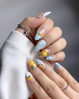 Lemon Shore close-up of 3D yellow lemons and soft white floral nail art