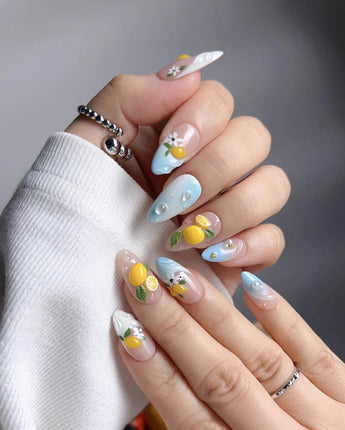 Lemon Shore close-up of 3D yellow lemons and soft white floral nail art