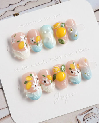 Lemon Shore press-on nails with dimensional lemons and delicate white flowers