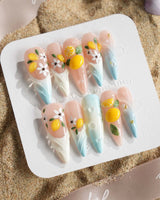 Lemon Shore glossy press-on nails inspired by lemon trees along the coast