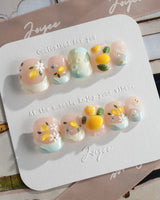 Lemon Shore hand-painted lemon nail art with white blossoms and glossy finish