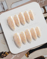 Lemon soda press-on nails with creamy white polka dots, vanilla yellow accents and glossy shine