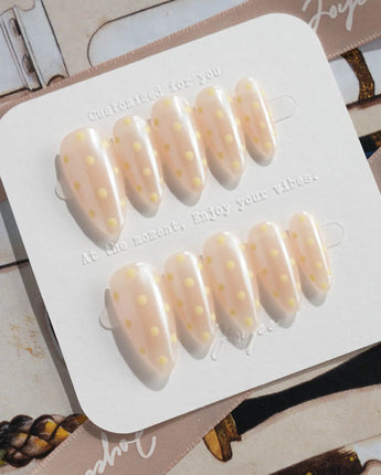 Lemon soda press-on nails with creamy white polka dots, vanilla yellow accents and glossy shine