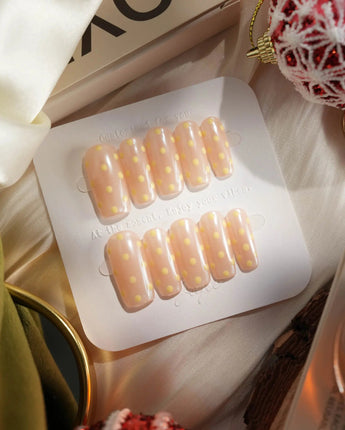 Lemon soda press-on nails with retro polka dot nail art and pearly aurora nude finish