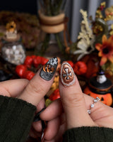 Lights Out press-on nails in short almond shape — Glitter Halloween, 3D Pumpkin & Cross.
