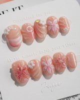 Lily-Nocturne press-on nails in extra short oval shape — Soft Peach Pink, 3D Lilies & Shell Textures.