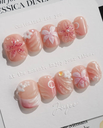 Lily-Nocturne press-on nails in extra short squoval shape — Soft Peach Pink, 3D Lilies & Shell Textures.