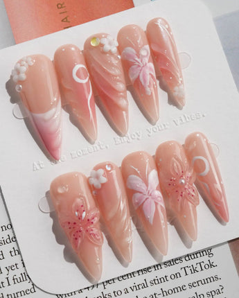 Lily-Nocturne press-on nails in long stiletto shape — Soft Peach Pink, 3D Lilies & Shell Textures.