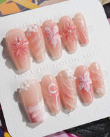 Lily-Nocturne press-on nails in medium coffin shape — Soft Peach Pink, 3D Lilies & Shell Textures.