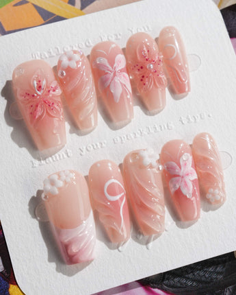 Lily-Nocturne press-on nails in medium coffin shape — Soft Peach Pink, 3D Lilies & Shell Textures.
