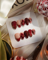 Lily Rouge press-on nails with glossy red cat-eye shimmer and 3D flower accents