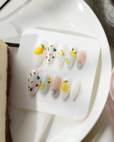 Limoncello custom summer nails with soft blue base and sculpted lemon charms