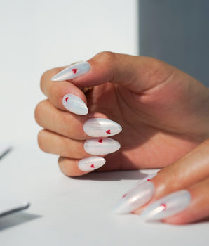 Little Luck handmade press-on nails featuring milky white red heart nails