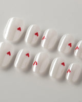 Little Luck press-on nails in extra short oval shape — milky white red heart nails