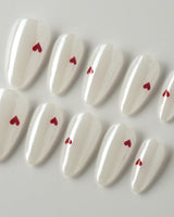 Little Luck press-on nails in short almond shape — milky white red heart nails