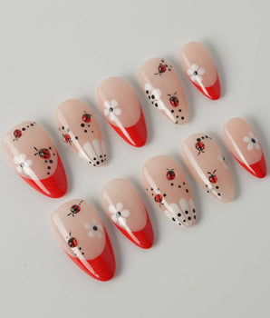 Lucky you handmade press-on nails featuring Red French, Daisy & Ladybug.