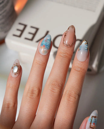 Monet sunrise press on nails hand-painted in blue with a red sun and gold frames