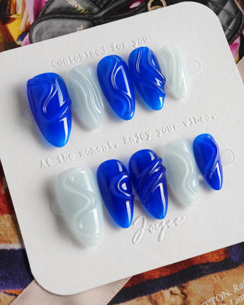 Majorelle Blue close-up of vibrant blue nail art with raised gel lines and pearls