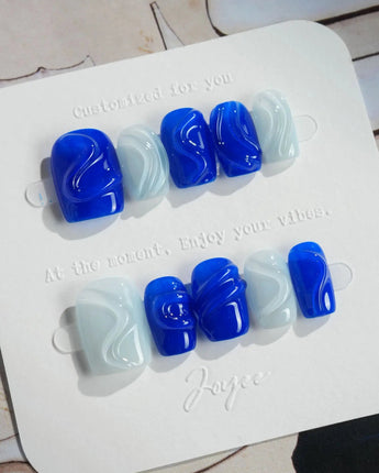 Majorelle Blue extra short square nails with dusty blue shimmer and 3D shell accents