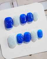 Majorelle Blue extra short squoval nails with dusty blue, 3D shells, and pearls
