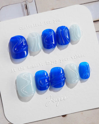 Majorelle Blue extra short squoval nails with dusty blue, 3D shells, and pearls