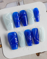Majorelle Blue medium coffin nails with silver-white shimmer, dusty blue, shells, and pearls
