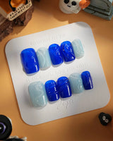 Majorelle Blue short square nails with architectural blue swirls and glossy finish