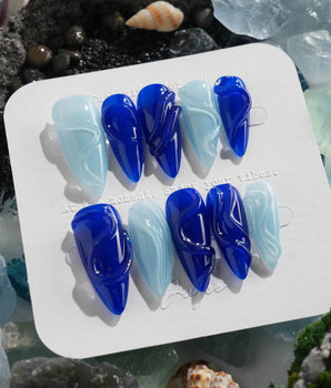 Majorelle Blue sculpted swirl nails with architectural gel lines and lacquer-like finish
