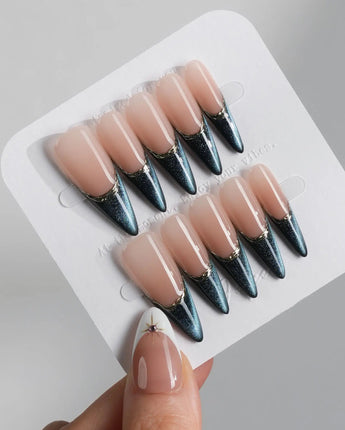 Malta Blue long stiletto nails with glowing blue cat-eye tips and gold French edging