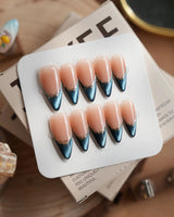 Malta Blue medium stiletto nails with midnight cat-eye French tips and gold outlines