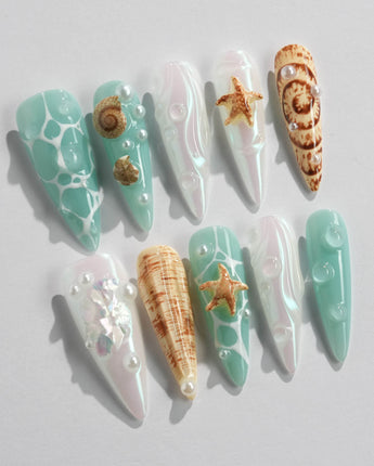 Mauritius Escape long stiletto nails with mint waves, conch shells, and starfish accents