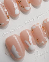 Meadow Bunny handmade press-on nails featuring nude,Hand-painted White Bunnies & Gold Foil Floral Accents