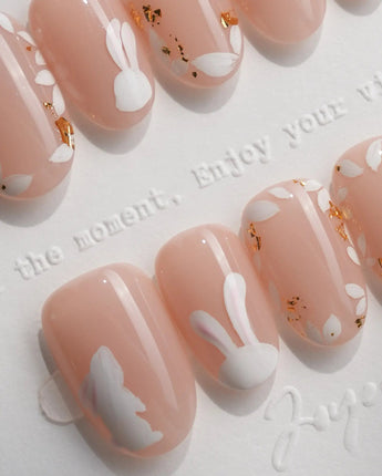 Meadow Bunny handmade press-on nails featuring nude,Hand-painted White Bunnies & Gold Foil Floral Accents