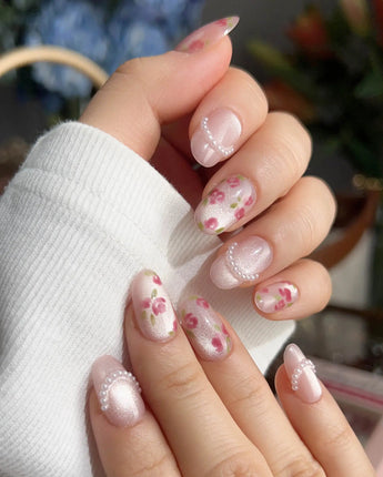 Meadow Glow summer bloom nails with tiny red flowers, light pink gel, and pearls
