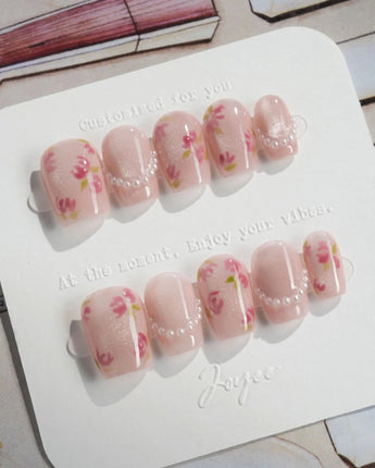 Meadow Glow extra short coffin nails with pink garden florals and glossy pearl detail