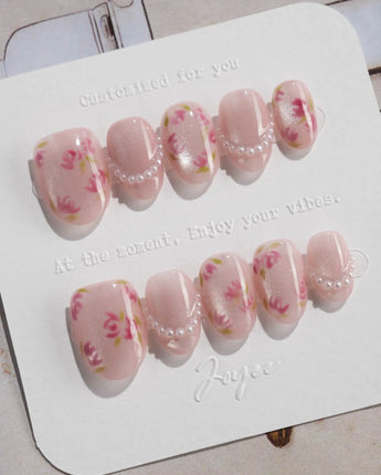 Meadow Glow extra short oval nails with vintage red blooms on a light pink base