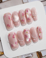 Meadow Glow medium square nails with tiny red floral print and fresh summer pearls