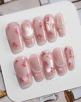 Meadow Glow medium square nails with tiny red floral print and fresh summer pearls