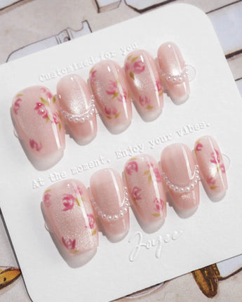 Meadow Glow short coffin nails with pastel floral art and small pearl accents