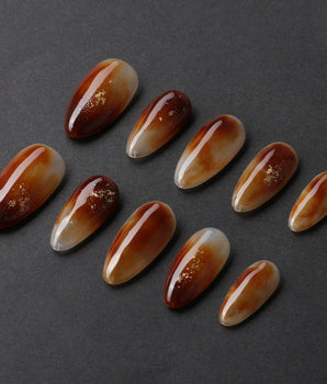 Onyx Shine handmade press-on nails featuring amber marble nails