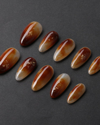 Onyx Shine handmade press-on nails featuring amber marble nails